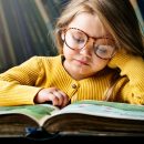 little-girl-wearing-eyeglasses-reading-a-story