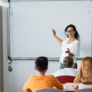 African,American,Teacher,Pointing,With,Hand,While,Standing,Near,Whiteboard