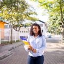 Portrait,Of,A,Young,College,Girl,Holding,Folders,And,Notebooks