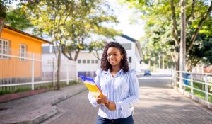 Portrait,Of,A,Young,College,Girl,Holding,Folders,And,Notebooks