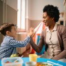 Happy,Little,Boy,Giving,High-five,To,His,African,American,Teacher