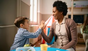 Happy,Little,Boy,Giving,High-five,To,His,African,American,Teacher