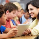 Pupils,In,Class,Using,Digital,Tablet,With,Teacher