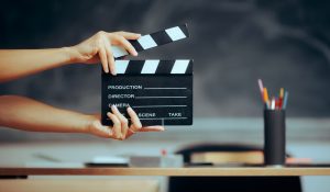 Hands,Holding,A,Film,Slate,In,A,School,Classroom,Professor