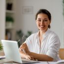 Happy,Casual,Beautiful,Woman,Working,On,A,Laptop,In,The