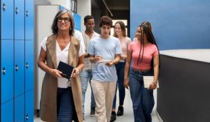 Multi-ethnic,Group,Of,High,School,Students,Walking,With,Their,Teacher