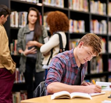 Student,,Writing,And,Notebook,In,Library,For,Study,,Education,And