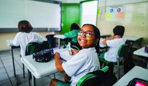 Portrait of a schoolgirl studying in the classroom at school