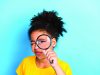 Young,Girl,With,Curly,Hair,Exploring,With,A,Magnifying,Glass