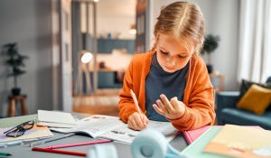 Child,Learning,Math.,Pensive,Blonde,Girl,Sitting,By,Desktop,And
