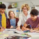 Multiethnic,Teenagers,Students,Focused,On,Learning,As,Teacher,Provides,Guidance