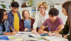 Multiethnic,Teenagers,Students,Focused,On,Learning,As,Teacher,Provides,Guidance