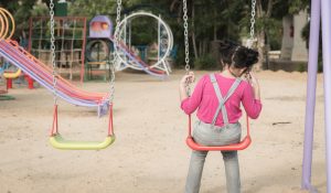 Lonely,Girl,Sitting,On,Chain,Swing,In,The,Park