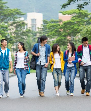 Asian,College,Students,Walking,Together,On,Campus