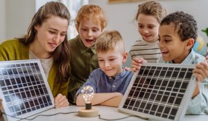 Young,Teacher,With,Solar,Panel,Learning,Pupils,About,Solar,Energy.