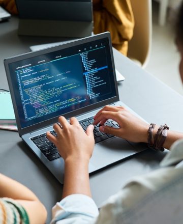 Teenage,Black,Girl,Coding,On,Laptop,,Sitting,At,Desk,With