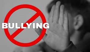 Stop,Bullying.,Upset,Little,Boy,Making,Stop,Gesture,,Black,And