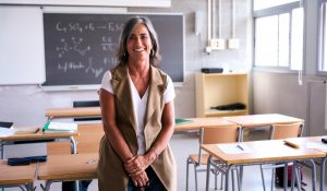 Portrait,Middle-aged,Female,High,School,Teacher,Looking,Smiling,At,Camera