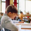 Happy,Schoolboy,Reading,From,A,Book,During,A,Class,In