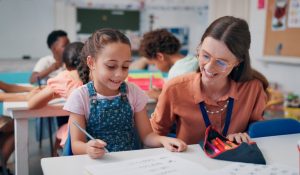 Education,,Girl,And,Teacher,In,Classroom,,Help,And,Support,With