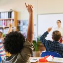 student-raising-hand-in-a-bright-primary-school-cl-2026-05-20-19-18-39-utc (1)