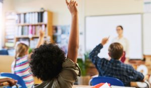 student-raising-hand-in-a-bright-primary-school-cl-2026-05-20-19-18-39-utc (1)
