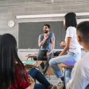 Teenager,Students,Listening,And,Talking,To,Friendly,Young,Male,Teacher