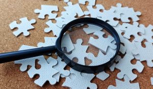 Research,And,Problem,Solving,Concept,With,Magnifying,Glass,And,Puzzle