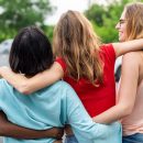 Four,Women,Standing,Outdoors,With,Arms,Around,Each,Other,,Showcasing
